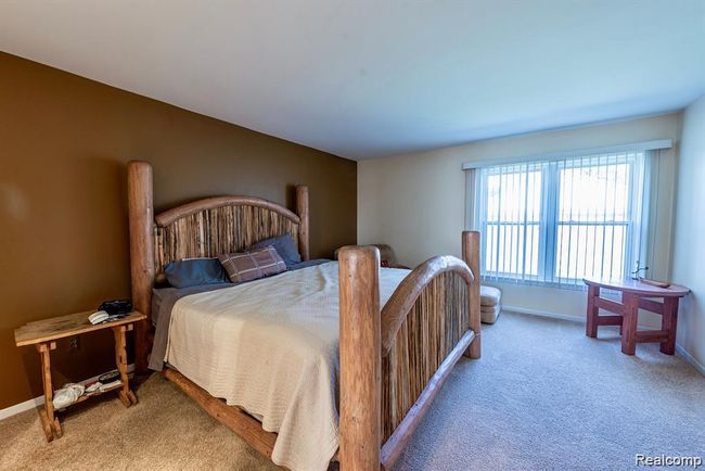 Carpeted bedroom featuring baseboards | Image 21