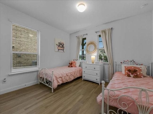 Bedroom featuring wood finished floors and baseboards | Image 13