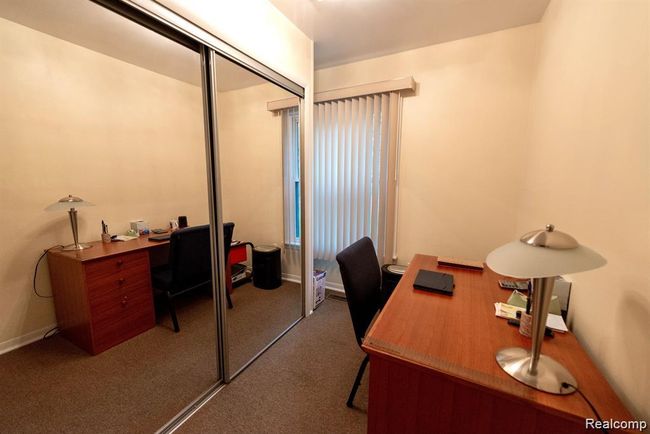 Office space featuring dark colored carpet and baseboards | Image 31