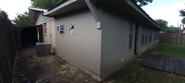 View of home's exterior featuring stucco siding and a wall mounted air conditioner | Image 33