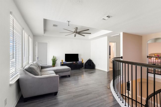 Living room featuring a raised ceiling, a ceiling fan | Image 20