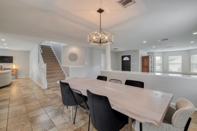 Dining room with stairs, recessed lighting, a chandelier, and light tile patterned floors | Image 11