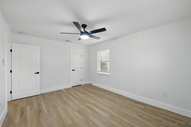 Unfurnished bedroom featuring light wood finished floors, baseboards, and a ceiling fan | Image 27