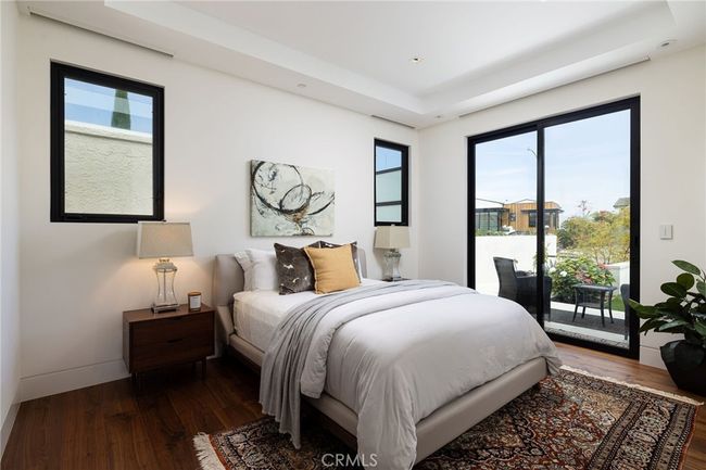 Front secondary bedroom features ensuite bathroom and private deck off your sliding doors. | Image 17