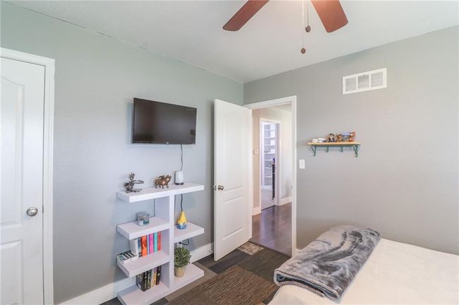 Bedroom featuring dark wood-style flooring and a ceiling fan | Image 33