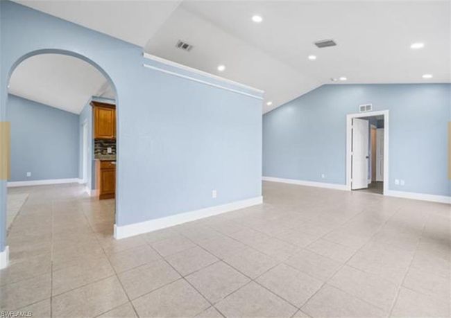 Spare room with vaulted ceiling, arched walkways, recessed lighting, and light tile patterned floors | Image 6