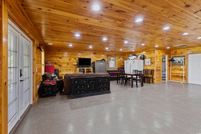Living area featuring recessed lighting, wood walls, and wood ceiling | Image 28