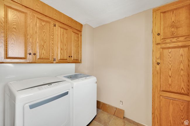 Washroom featuring cabinet space, baseboards, and tile patterned floors | Image 9