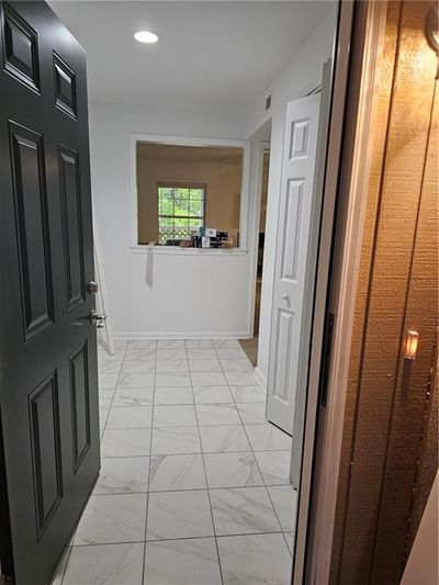 Tiled entry with double bifold door coat closet | Image 2