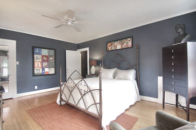 Bedroom with baseboards, light wood finished floors, and ceiling fan | Image 14