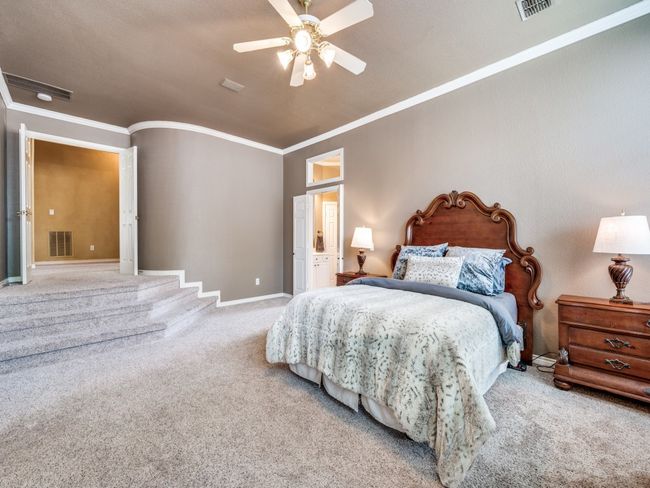 Carpeted bedroom with ornamental molding, vaulted ceiling, and a ceiling fan | Image 18