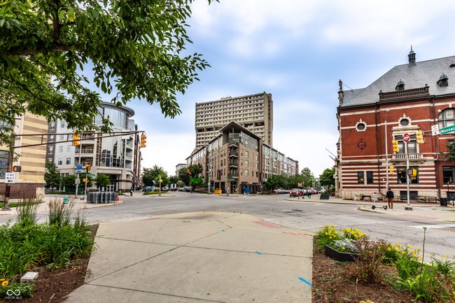 view of asphalt street with sidewalks, street lighting, and curbs | Image 38