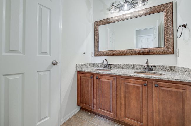 Full bathroom featuring tile patterned flooring, double vanity, and a sink | Image 25