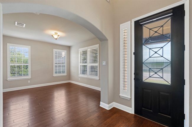 Foyer entrance with arched walkways and dark wood-type flooring | Image 5