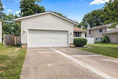 View of front of home with a garage and a front lawn | Image 3