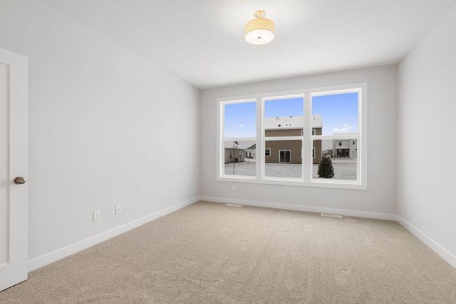 The master bedroom is a spacious retreat, offering a perfect balance of comfort and style with large windows, a huge walk-in closet, and a peaceful ambiance ideal for relaxation. | Image 21