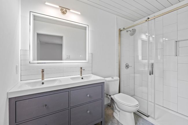 Primary bathroom with dual vanity, custom shiplap ceiling & walk-in shower | Image 18