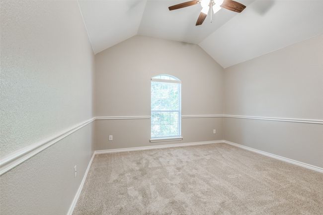 Unfurnished room with vaulted ceiling, carpet, baseboards, and ceiling fan | Image 20