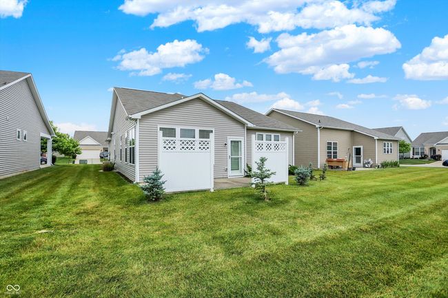 back of house with a yard and a shingled roof | Image 18