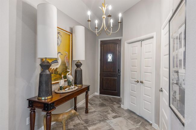 At the property's entrance, an upgraded chandelier serves as an elegant focal point, casting a warm glow and adding a touch of luxury. | Image 12