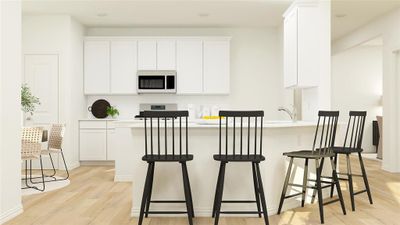 Kitchen featuring backsplash, a kitchen breakfast bar, light wood-type flooring, and white cabinets | Image 2