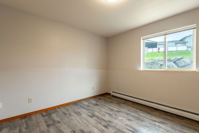 Empty room with a baseboard radiator and wood finished floors | Image 21