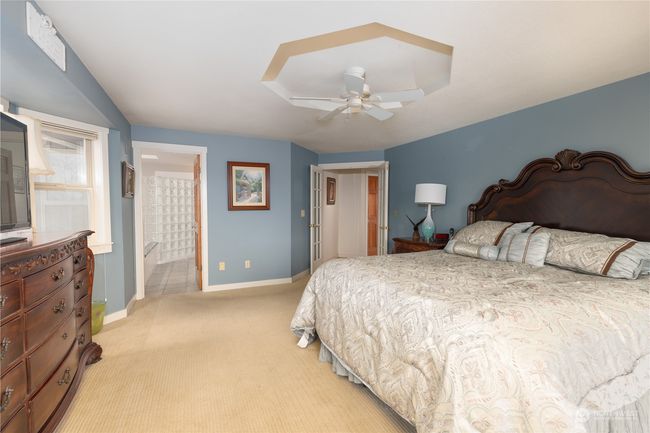 Primary bedroom suite with French doors looking toward bath | Image 29