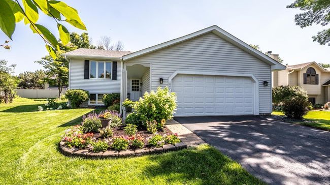 Another front view with great curb appeal -architectural shingles, gutters & downspouts on front & back, aluminum soffits & fascia, storm/screen combination door on front. | Image 4