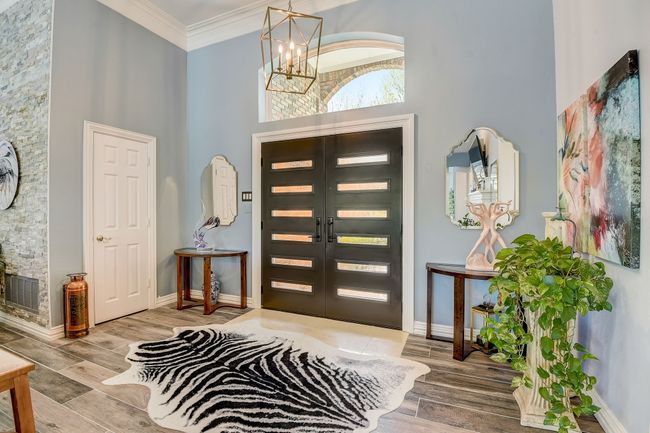 A grand entrance welcomes you with soaring ceilings and a custom front door | Image 6