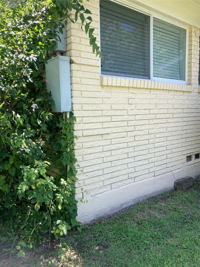front corner showing where electric enters the house driveway side | Image 19