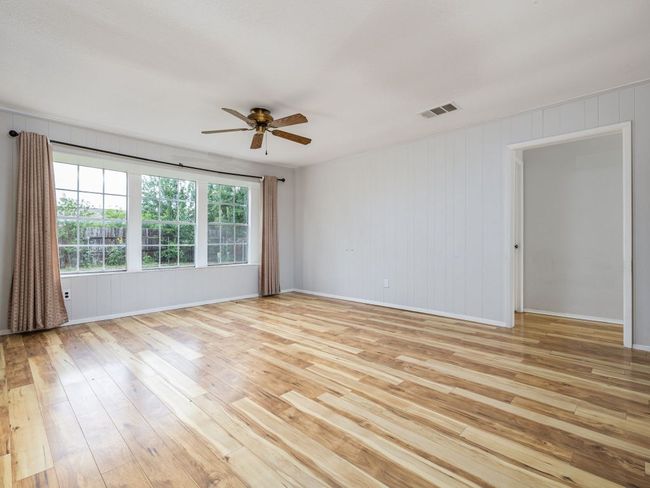 Unfurnished room with light wood-type flooring and ceiling fan | Image 17