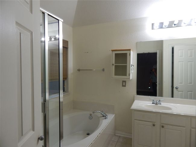 Bathroom with vanity, a garden tub, and tile patterned flooring | Image 13