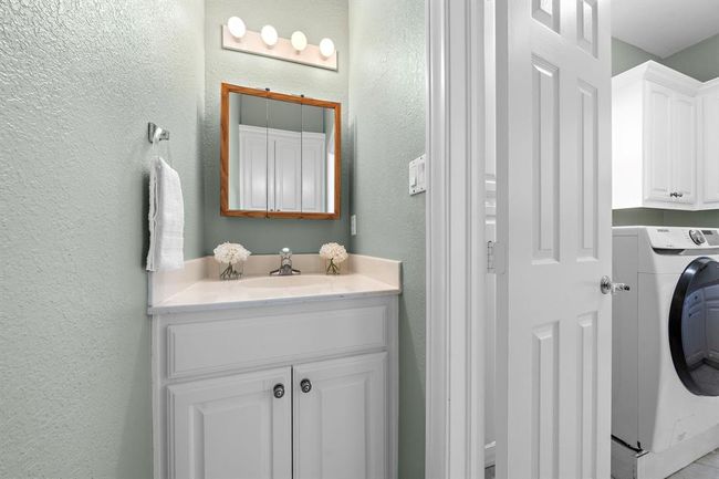 Half bath off of the laundry room is just down the hallway from the kitchen, and next to another study area. | Image 38