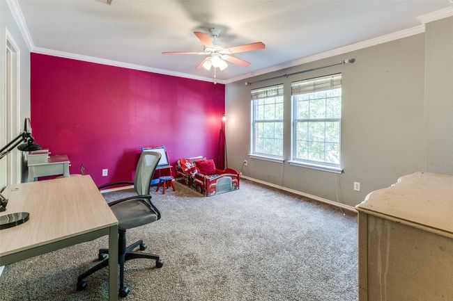 Home office with a ceiling fan, carpet floors, ornamental molding, an accent wall, and baseboards | Image 20