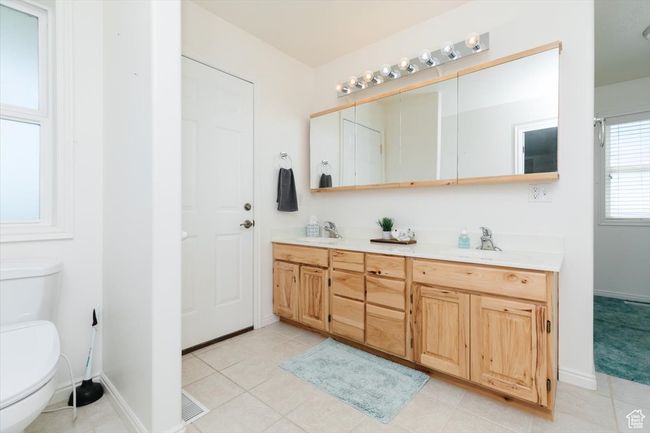 Bathroom with double vanity and tile patterned flooring | Image 29