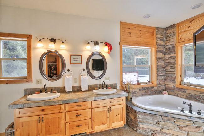 Full bathroom featuring a sink, a healthy amount of sunlight, and double vanity | Image 17