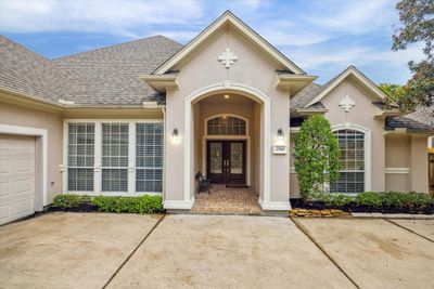 The front exterior's meticulous landscaping and attractive design make a striking first impression. The welcoming entrance is just a preview of the home's inviting interior. | Image 2