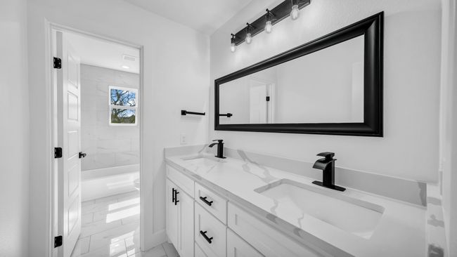 Bathroom featuring double vanity, marble finish floor, and a sink | Image 30