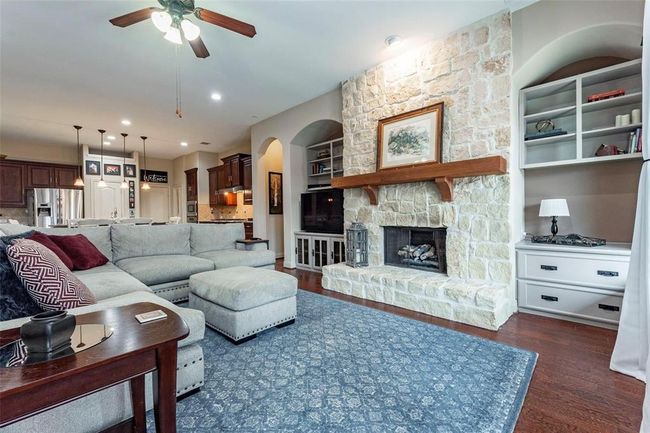 Stone fireplace with wood decorator’s mantle. Built in book shelves on either side. | Image 31