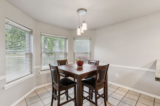 Dining room with light tile patterned flooring and healthy amount of natural light | Image 9