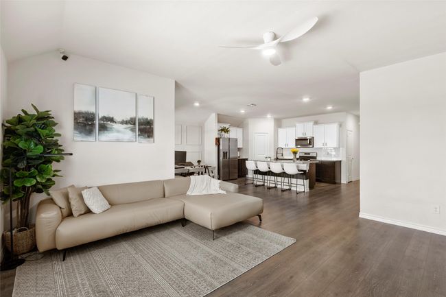 Living room featuring baseboards, a ceiling fan, dark wood-style floors, and recessed lighting | Image 22