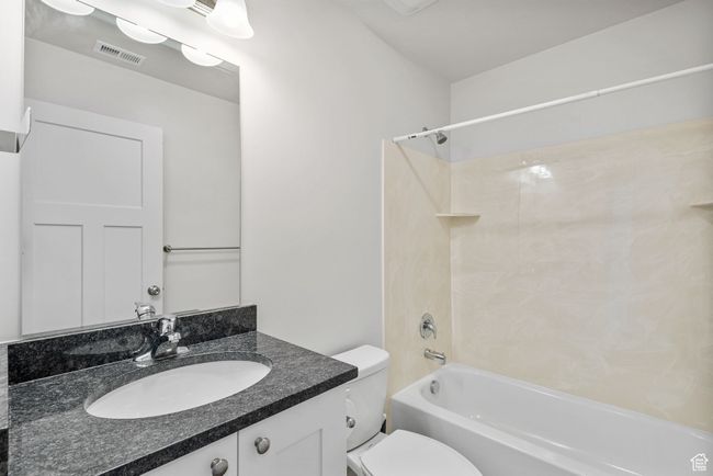 Basemen Full Bathroom featuring toilet, bathing tub / shower combination, and vanity with Granite Countertops | Image 30