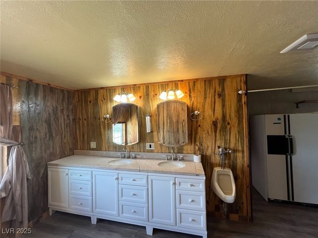 Bathroom with a sink, wood walls, and double vanity | Image 9