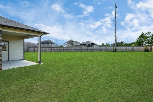 Experience outdoor living at its finest on this expansive covered patio, thoughtfully designed for BBQs and delightful outdoor dining. | Image 42