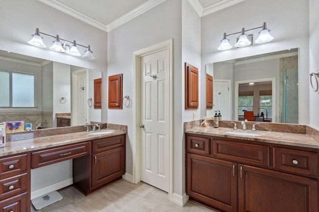 Full bath with two vanities, a sink, and ornamental molding | Image 25