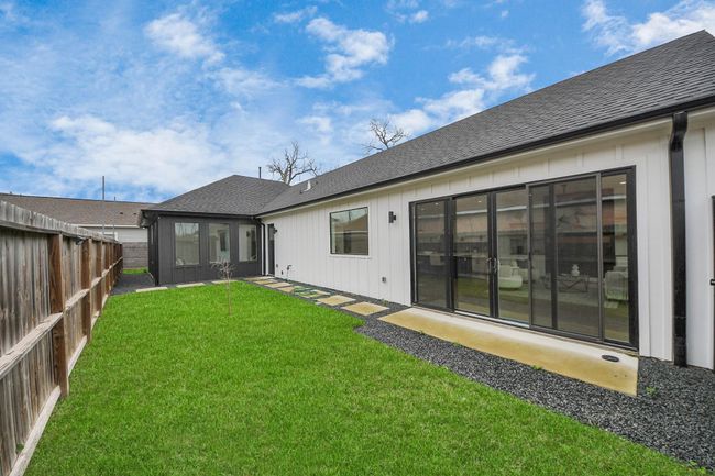 The yard has paving stones and plenty of green space. | Image 31