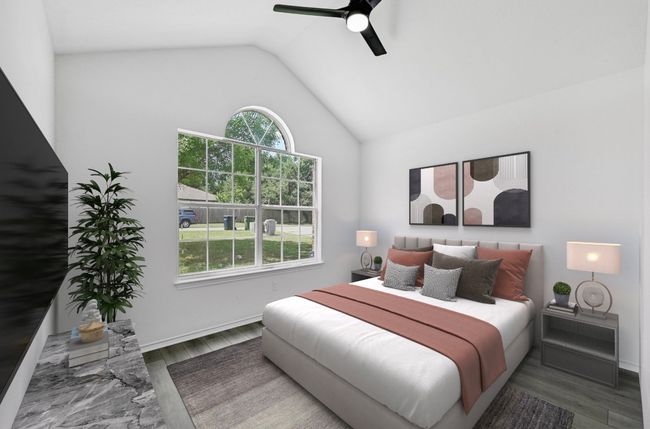 Bedroom featuring wood finished floors, vaulted ceiling, and a ceiling fan | Image 21