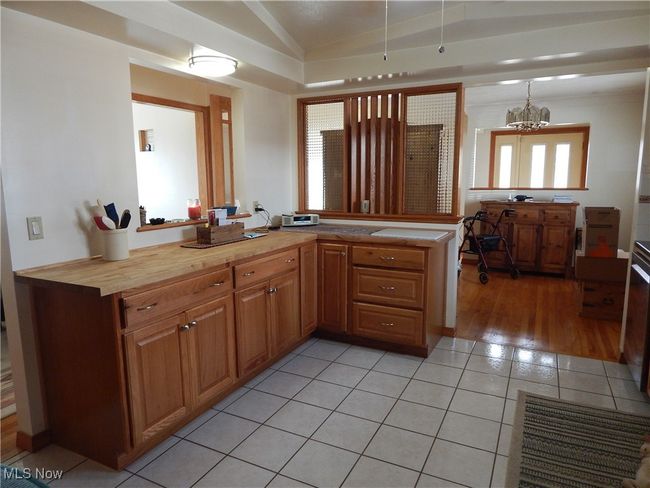 You'll enjoy an abundance of Butcher Block Counterspace that overlooks Dining Room & Living Room. Great for Cooking, Prepping, Baking, Serving & Entertaining. Ceramic Tile flooring and Ceiling fan. | Image 8
