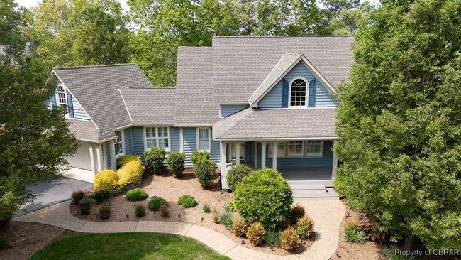 View of front of house featuring covered porch, aphalt driveway, a shingled roof, and a garage | Image 8