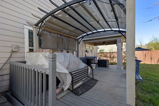 Wooden terrace featuring a lawn, fence, ceiling fan, and a pergola | Image 36